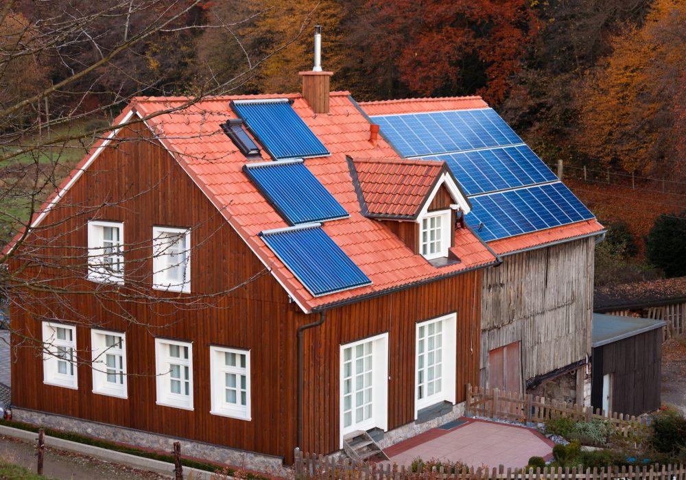 House with solar panels sun heating system on roof